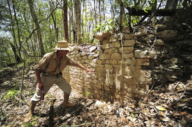 A National Institute of Anthropology and History (INAH) worker shows the remains of a building at the newly discovered ancient Maya city Chactun in Yucatan peninsula