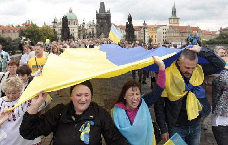 Ukrainians carry the national flag to celebrate the country's Independence Day.