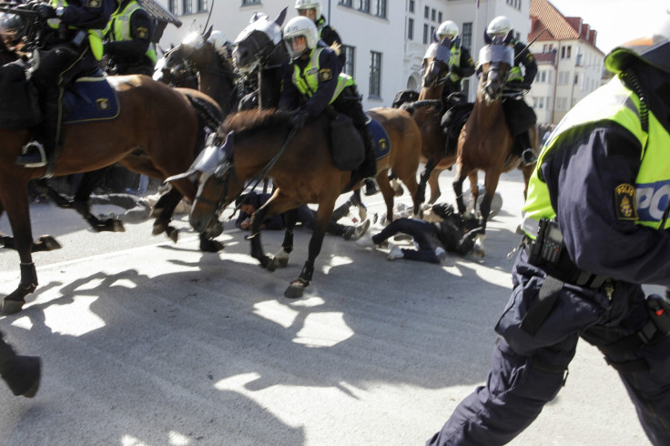Protesters are seen below mounted police who are controlling a demonstration against an election meeting organised by right-wing political group The Party of the Swedes (Svenskarnas Parti) at a square in central Malmo