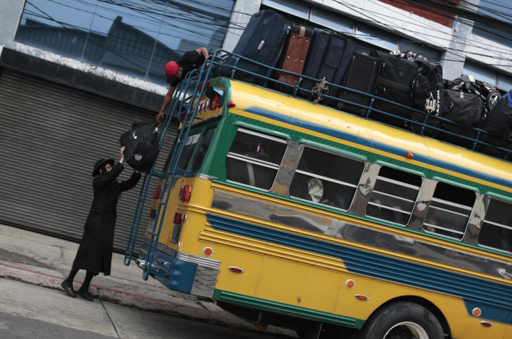 A man from the Lev Tahor loads bags onto a bus as the community depart San Juan La Laguna. (Reuters)