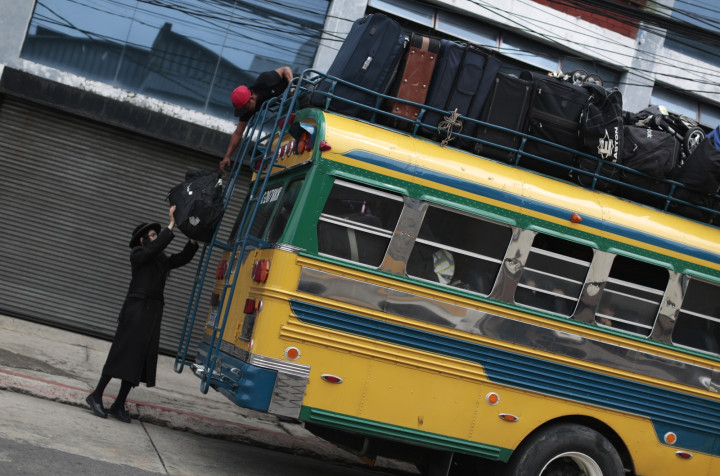 A man from the Lev Tahor loads bags onto a bus as the community depart San Juan La Laguna. (Reuters) A man from the Lev Tahor loads bags onto a bus as the community depart San Juan La Laguna. (Reuters)