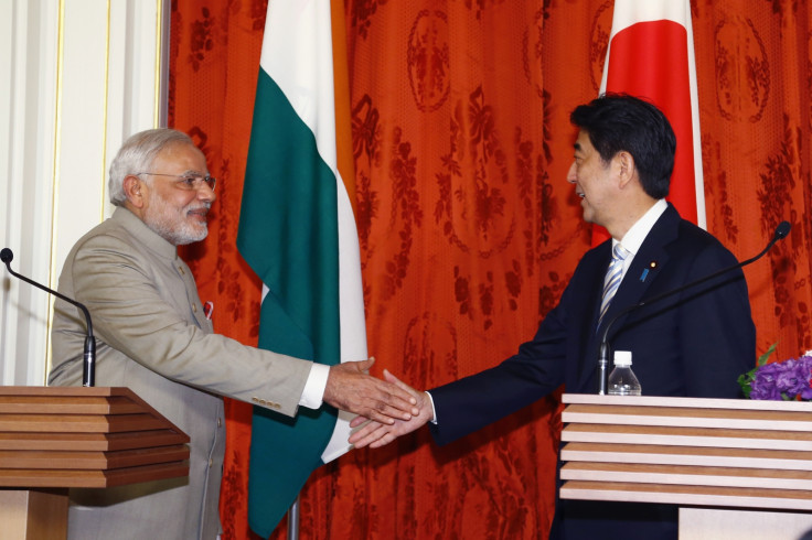 India's Prime Minister Narendra Modi (L) shakes hands with Japan's Prime Minister Shinzo Abe