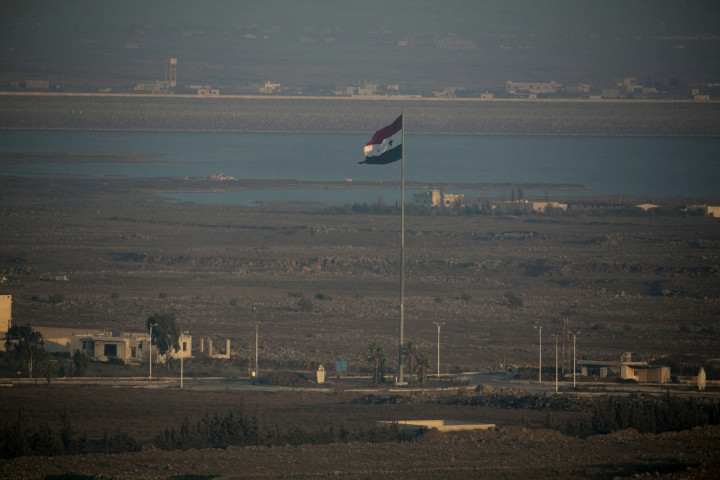 A Syrian flag flutters on a pole near the Quneitra crossing in Syria close to the border fence with the Israeli-occupied Golan Heights A Syrian flag flutters on a pole near the Quneitra crossing in Syria close to the border fence with the Israeli-occupied Golan Heights