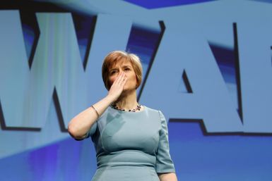 Scotland's Deputy First Minister Nicola Sturgeon blows a kiss following a speech in front of a Forward banner