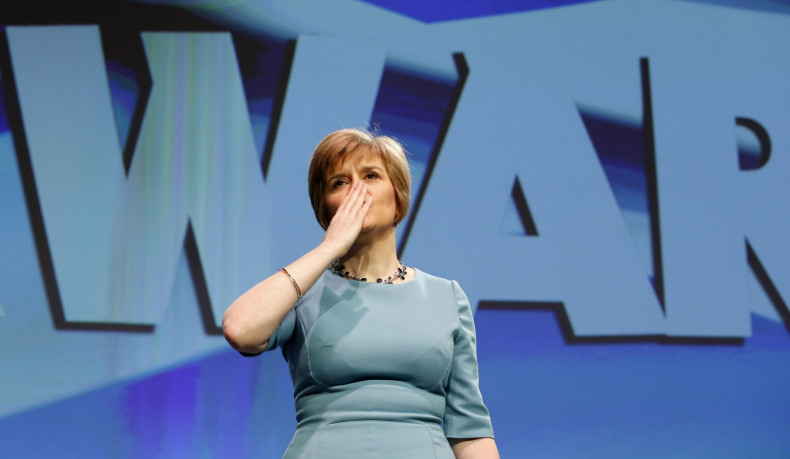 Scotland's Deputy First Minister Nicola Sturgeon blows a kiss following a speech in front of a Forward banner