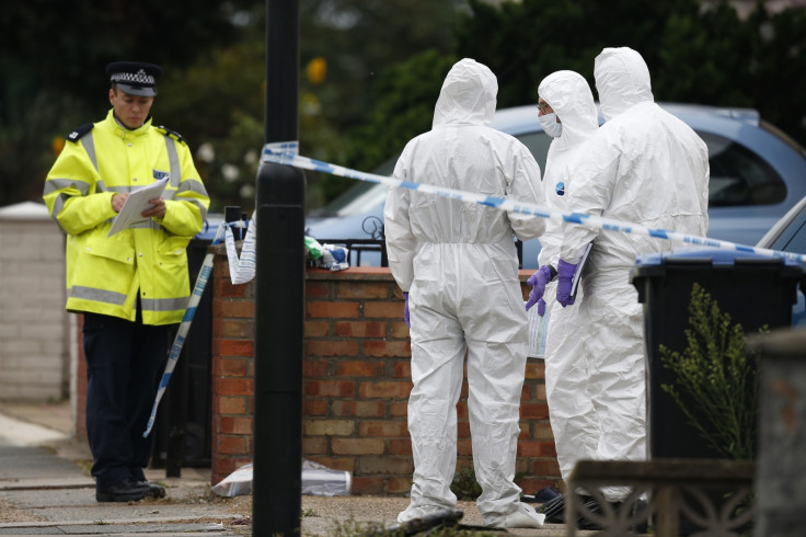 Forensic investigators and a police officer at the scene Edmonton where Palmira Silva was gruesomely slain