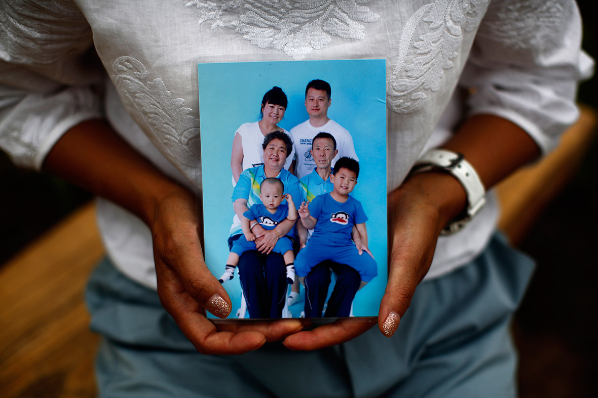 Cheng Liping shows a family photo featuring her missing husband.  Cheng said her life has been totally changed since the incident. Their two sons, who dont know about the missing plane, keep asking her when their dad is coming bac