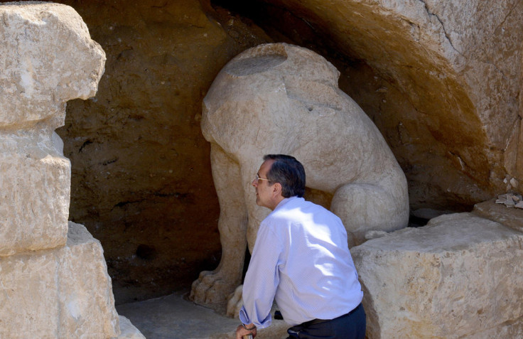 Greek PM Antonis Samaras takes a closer look at the ancient sphinxes discovered by archaeologists