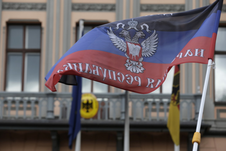 A protester waves a self-declared Donetsk People's Republic flag in front of Germany's embassy in Riga, May 8, 2014. About 40 people from the Latvian Russian Union staged a protest denouncing Ukraine's government military actions against pro-Russian se