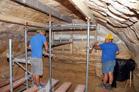 Archaeologists work inside the tholos, a type of Greek subterranean domed tomb chamber shaped like a beehive