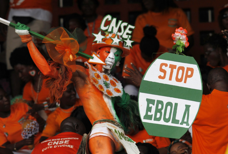 A fan of Ivory coast holds a sign with a message against Ebola during the 2015 African Nations Cup between Ivory Coast and Sierra Leone
