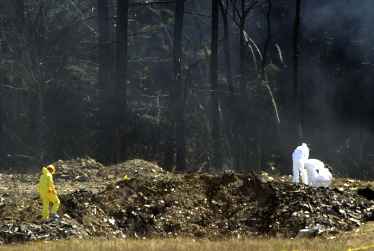 Workers comb the wreckage of Flight 93