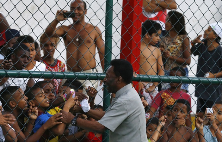 Pelé greets children at the unveiling of the energy-saving football pitch at the Morro da Mineira favela in Rio de Janeiro, Brazil.