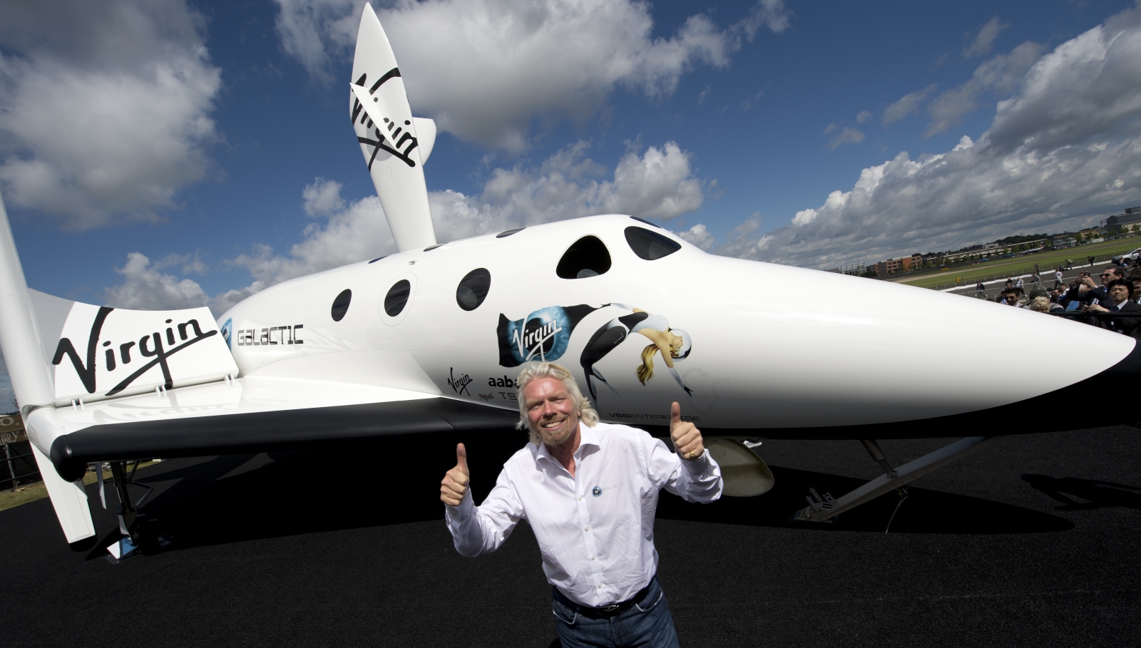 Branson in front of a model of the Virgin Galactic craft. (Getty)