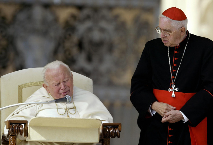 Argentinean Cardinal Jorge Maria Mejia (R) looks at Pope John Paul II during his weekly general audience in St Peter's square at the Vatican 08 October 2003