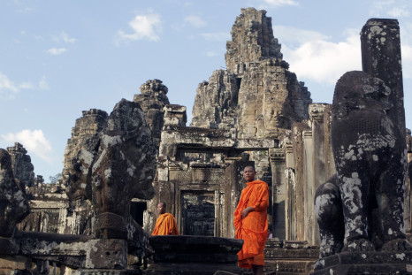 Monks walk around Bayon temple in Siem Reap