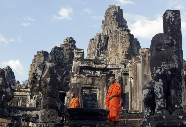 Monks walk around Bayon temple in Siem Reap