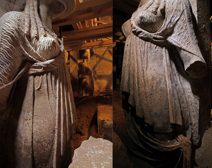 The caryatid statues being excavated from sandy soil in the Amphipolis tomb