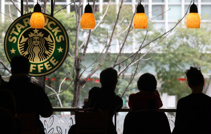 Customers sit inside a branch of Starbucks in the Jimbocho district of Tokyo