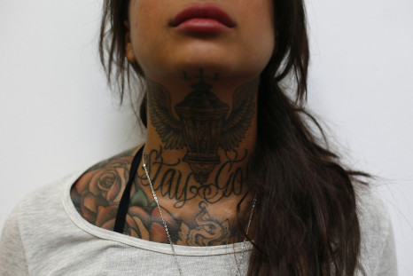 Cleo displays tattoos on her neck during the ninth London Tattoo Convention in London September 27, 2013