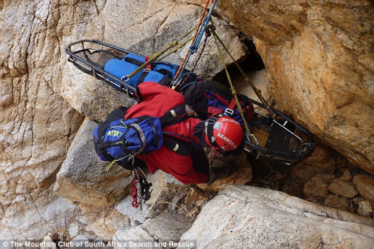 A rescue worker lowers a stretcher to help Tsenolo Shadrack Rasello, whose leg had be amputated after becoming trapped climbing. (Mountain Club of South Africa Search and Rescue)