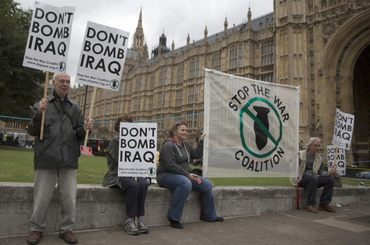 Demonstrators outside of the Houses Parliament protest against British military strikes in Iraq