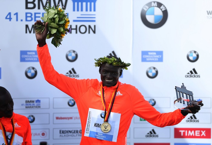 Dennis Kimetto of Kenya holds up his trophy as he celebrates during the awards ceremony for the 41st Berlin marathon