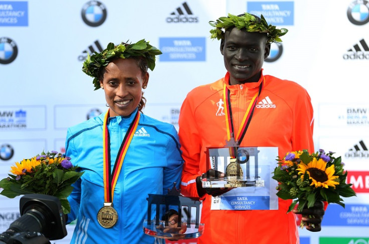 Dennis Kimetto stands with Ethiopia's Tirfi Tsegaye, who won the women's race