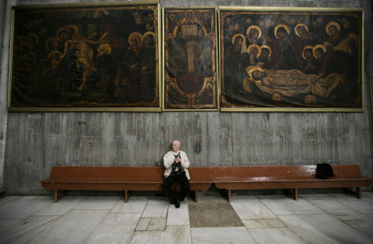 A tourist rests during a visit at the Church of the Holy Sepulchre in Jerusalem's Old City