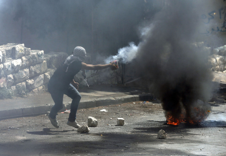 A Palestinian prepares to throw fire crackers during clashes with Israeli police in the East Jerusalem neighbourhood of Wadi al-Joz September 8, 2014.
