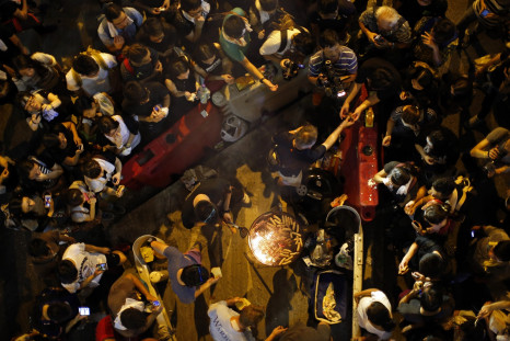 A man cooks sausages for protesters, who are blocking the main street to the financial Central district, outside the government headquarters in Hong Kong September 29, 2014
