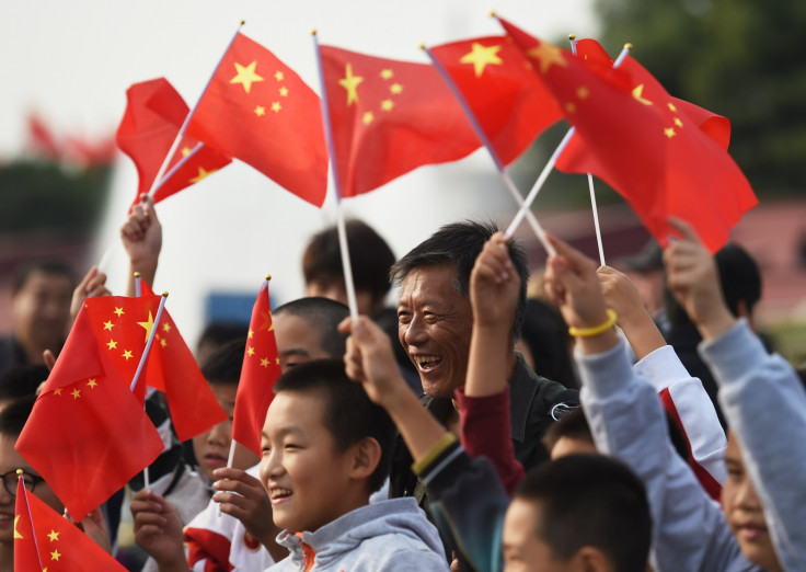 China National Day - People wave the national flag in Tiananmen Square at a memorial service to the nation's heros