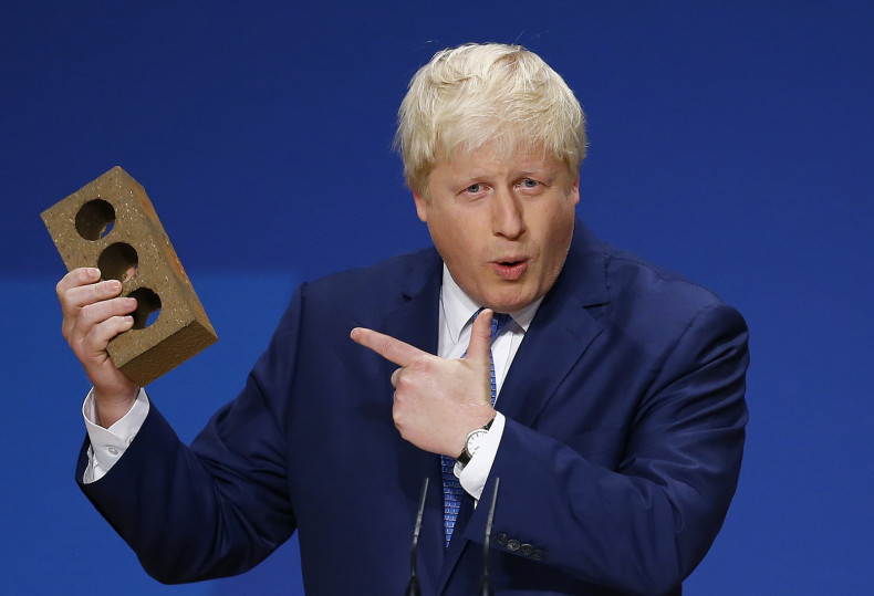 London Mayor Boris Johnson holds a brick as he speaks at the Conservative Party Conference in Birmingham, central England, September 30, 2014