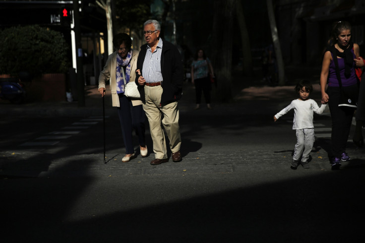 Pensioners cross the street in Madrid September 30, 2014.