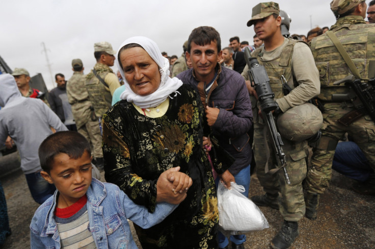Syrian Kurds walk through Mursitpinar border crossing to return to their homes in the Syrian city of Kobani