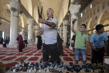Palestinians display rubber bullets and stun grenades used by Israeli riot police inside the Al-Aqsa Mosque compound, Islam's third most holy site