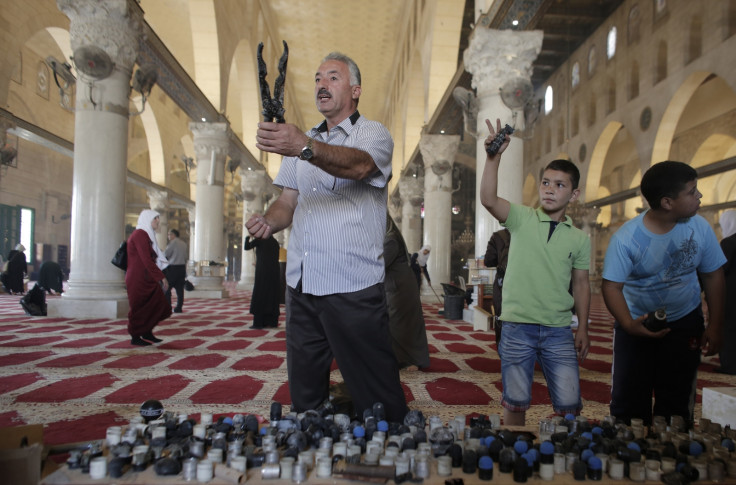 Palestinians display rubber bullets and stun grenades used by Israeli riot police inside the Al-Aqsa Mosque compound, Islam's third most holy site