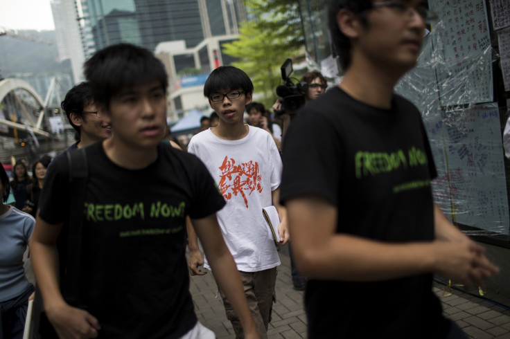 Joshua Wong (C), leader of the student movement,walks with Hong Kong Federation of Students's secretary-general Alex Chow (R) and vice secretary of the Hong Kong Federation of Students Lester Shum