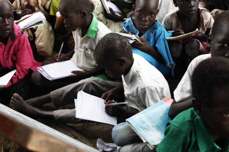 School children sit under a tree where classes are held in Leer, Unity State, July 16, 2014