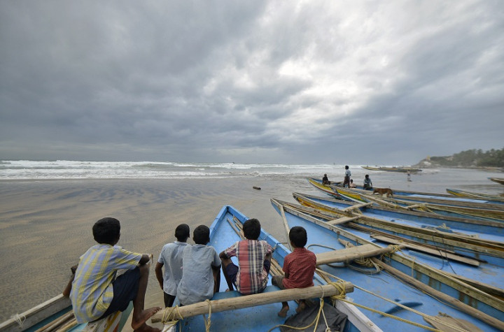 Children sit on fishing boats by the shore before being evacuated at Visakhapatnam district in the southern Indian state of Andhra Pradesh Children sit on fishing boats by the shore before being evacuated at Visakhapatnam district in the southern Indian state of Andhra Pradesh