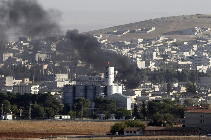 Smoke rises over Kobani during fighting between isis militants and Kurdish fighters last week. (Getty)