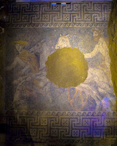 Blue mosaic floor of the Greek god Hermes leading a chariot bearing an unknown man