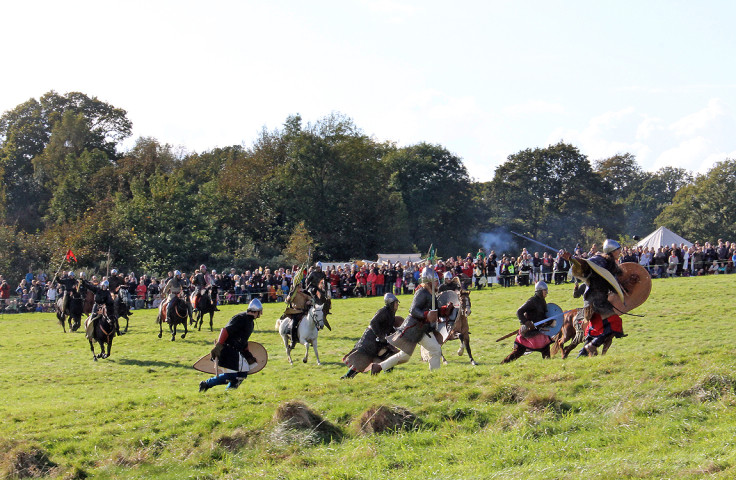 Norman troops and knights race towards the Anglo-Saxons in a dramatic re-enactment of the battle