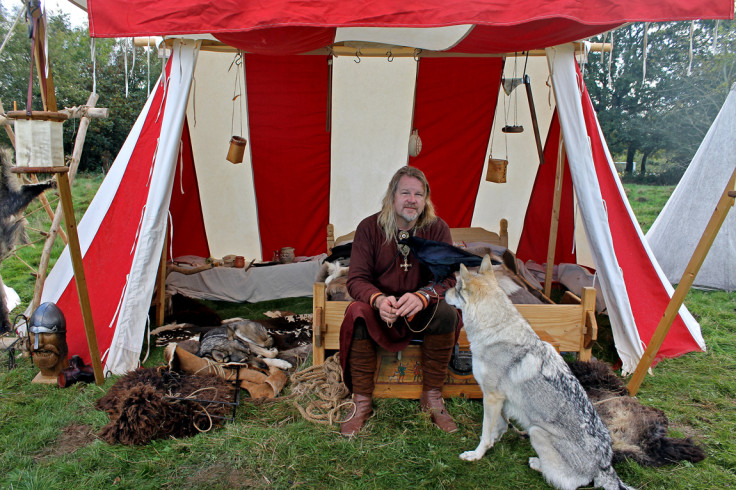 Andrew Johnson sits with his pet raven and two wolf dogs (German shepherds crossed with Carpathian or Canadian wolves)