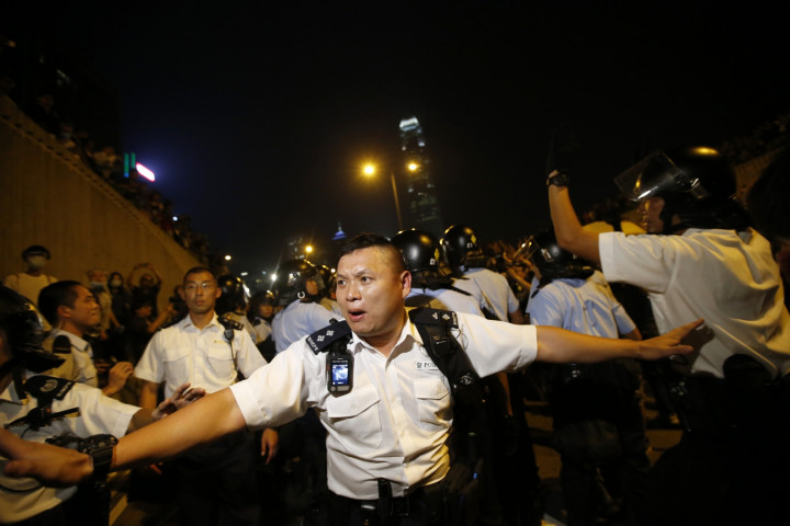 Police officers wielding pepper spray tore down barricades and concrete slabs built up by pro-democracy demonstrators Police officers wielding pepper spray tore down barricades and concrete slabs built up by pro-democracy demonstrators