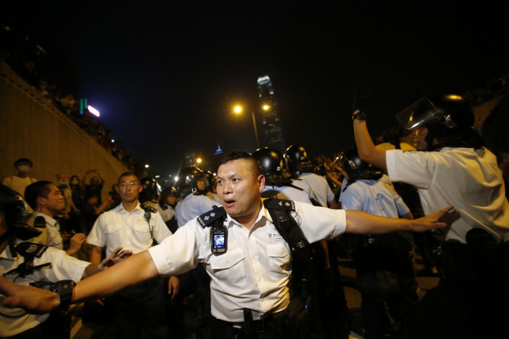 Police officers wielding pepper spray tore down barricades and concrete slabs built up by pro-democracy demonstrators