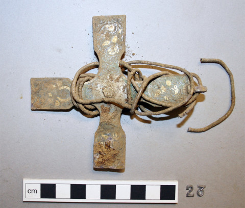 A medieval cross made from solid silver has been discovered as part of a Viking treasure hoard found in Scotland