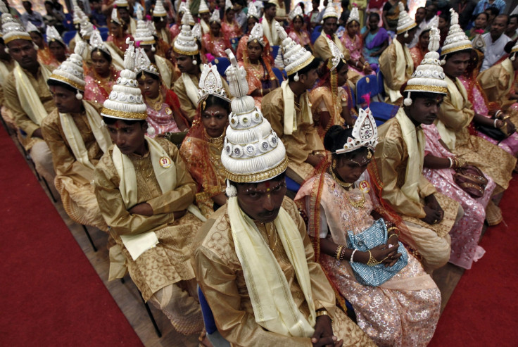 Brides and grooms sit before the start of a mass marriage ceremony in Kolkata June 18, 2014.