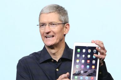 Apple CEO Tim Cook holds an iPad Air 2 during a presentation at Apple headquarters in Cupertino, California October 16, 2014