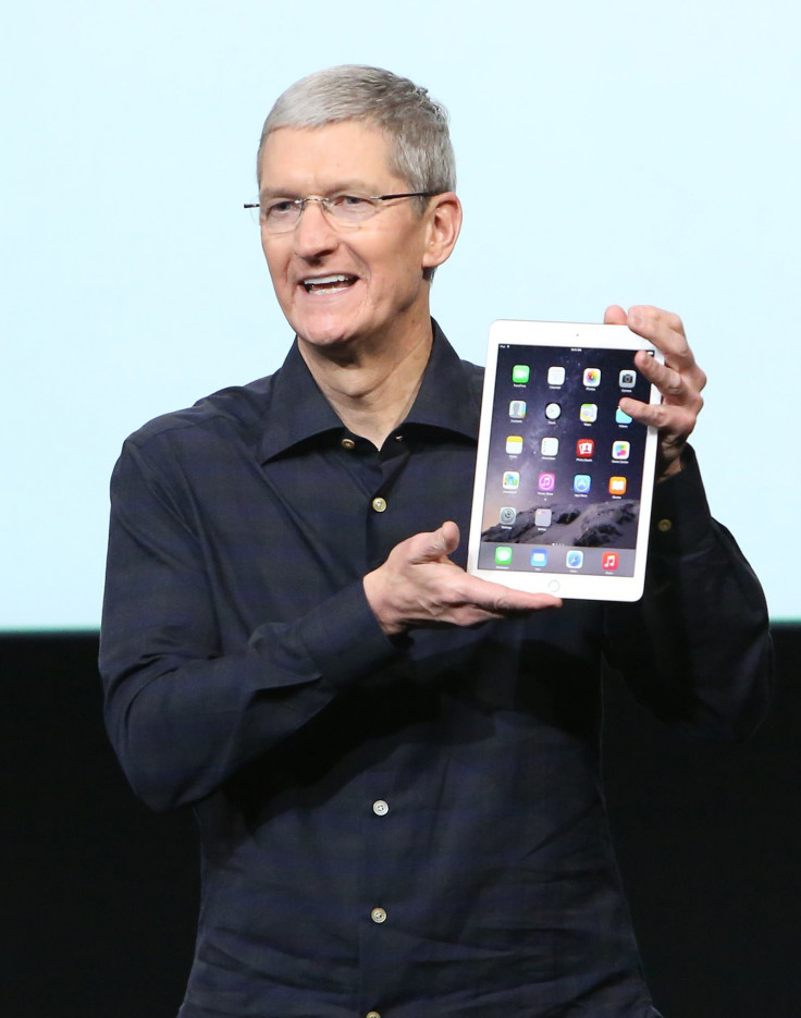 Apple CEO Tim Cook holds an iPad Air 2 during a presentation at Apple headquarters in Cupertino, California October 16, 2014